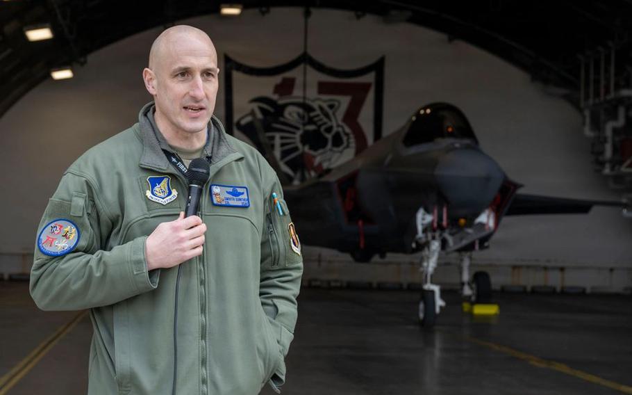 U.S. Air Force Col. Jeremy Guinther delivers a speech in front of a U.S. Air Force F-35A Lightning II during the F-35 first aircraft arrival at Misawa Air Base.